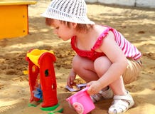 The Little Girl In Sand Stock Image