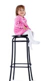 The Little Girl Sits On A High Chair Stock Images