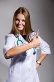 The Nurse With A Syringe Shows A Thumb Royalty Free Stock Images The Nurse With A Syringe Shows A Thumb Royalty Free Stock Images