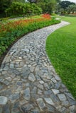 The Stone Block Walk Path In The Park With Green Grass And Flowers Background Royalty Free Stock Images