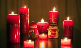 Mr. and Mrs. Snowman getting warm in front of the candle. stock images Mr. and Mrs. Snowman getting warm in front of the candle. stock images