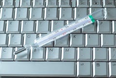 A THERMOMETER ON A COMPUTER KEYBOARD royalty free stock photos A THERMOMETER ON A COMPUTER KEYBOARD royalty free stock photos
