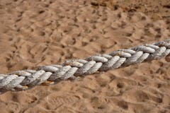 Thick natural rope on the background of sand royalty free stock image Thick natural rope on the background of sand royalty free stock image