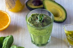 Thick nutritious smoothies, which include: avocado, apple, banana, spinach, orange juice, honey, flax seeds, mint and olive oil. royalty free stock photo Thick nutritious smoothies, which include: avocado, apple, banana, spinach, orange juice, honey, flax seeds, mint and olive oil. royalty free stock photo