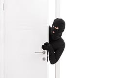 Thief breaking into a room and carefully looking around Royalty Free Stock Images Thief breaking into a room and carefully looking around Royalty Free Stock Images