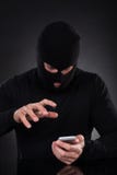 Thief trying to access a stolen mobile phone royalty free stock photos Thief trying to access a stolen mobile phone royalty free stock photos