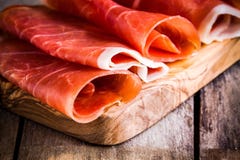 Thin slices of prosciutto closeup on a cutting board royalty free stock photo Thin slices of prosciutto closeup on a cutting board royalty free stock photo