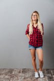Thinking cheerful young blonde woman standing isolated royalty free stock photography Thinking cheerful young blonde woman standing isolated royalty free stock photography