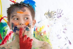 Thoughtful creative little boy covered in paint Stock Image Thoughtful creative little boy covered in paint Stock Image