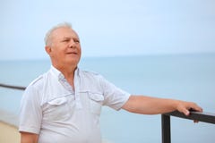 Thoughtful senior on veranda near seacoast stock photography Thoughtful senior on veranda near seacoast stock photography