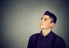Thoughtful young man looking up stock photos Thoughtful young man looking up stock photos