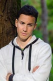 Thoughtful young man standing in the forest Royalty Free Stock Photography Thoughtful young man standing in the forest Royalty Free Stock Photography