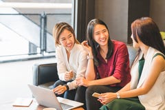 Three Asian girls chatting on sofa at cafe or coffee shop together. Gossip talks, Casual lifestyle with gadget technology concept stock image Three Asian girls chatting on sofa at cafe or coffee shop together. Gossip talks, Casual lifestyle with gadget technology concept stock image