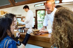 Three beautiful young women buying meatballs on a food truck. royalty free stock photos Three beautiful young women buying meatballs on a food truck. royalty free stock photos