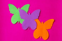Three bright and coloured butterflies made of soft material on a fuchsia rag background stock photography Three bright and coloured butterflies made of soft material on a fuchsia rag background stock photography