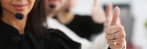 Three call centre service operators arm show OK Stock Photos Three call centre service operators arm show OK Stock Photos