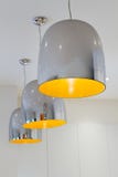 Three chrome and yellow contemporary kitchen pendant lighting stock photo Three chrome and yellow contemporary kitchen pendant lighting stock photo