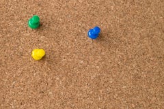 Three Colored Thumb Tacks on Cork Board stock images Three Colored Thumb Tacks on Cork Board stock images