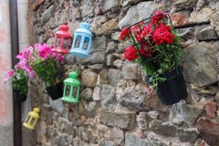 Three colorful lanterns with three geraniums, one red and one pink stock photos Three colorful lanterns with three geraniums, one red and one pink stock photos