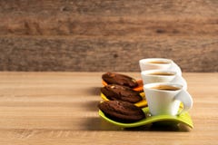 Three cups of fresh coffee and chocolate biscuits placed on table royalty free stock photos Three cups of fresh coffee and chocolate biscuits placed on table royalty free stock photos
