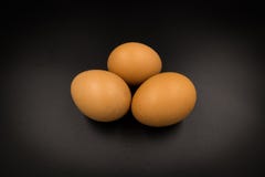 Three eggs orange brown on black background royalty free stock photos Three eggs orange brown on black background royalty free stock photos