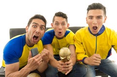 Three friends sitting on sofa wearing yellow sports shirts screaming cheering at camera with enthusiasm, white stock photography Three friends sitting on sofa wearing yellow sports shirts screaming cheering at camera with enthusiasm, white stock photography