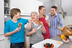 Three generation living together: happy family in the kitchen. royalty free stock images Three generation living together: happy family in the kitchen. royalty free stock images