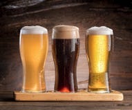 Three glasses of beer on the wooden table. stock photography Three glasses of beer on the wooden table. stock photography