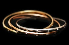 Three gold bracelets isolated