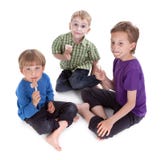 Three kids eating ice lolly Stock Image Three kids eating ice lolly Stock Image