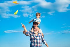 Three men generation. Cute son with dad playing outdoor. Fathers day - grandfather, father and son are hugging and stock photography Three men generation. Cute son with dad playing outdoor. Fathers day - grandfather, father and son are hugging and stock photography