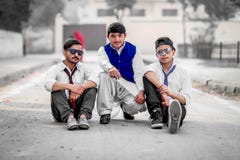 Three Men Sitting on Gray Concrete Road Stock Photos Three Men Sitting on Gray Concrete Road Stock Photos