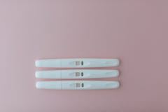 Three negative pregnancy tests on the pink background stock photography Three negative pregnancy tests on the pink background stock photography