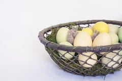 Three Tiny Felted Bunnies or Rabbits Hide in Basket of Pale Colo stock image Three Tiny Felted Bunnies or Rabbits Hide in Basket of Pale Colo stock image