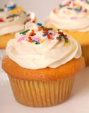 Three Vanilla Cupcakes With Sprinkles Royalty Free Stock Images