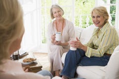 Three Women In Living Room With Coffee Smiling Royalty Free Stock Photography Three Women In Living Room With Coffee Smiling Royalty Free Stock Photography