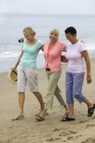 Three Women Walking On Beach Stock Image
