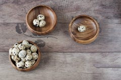 Three wooden bowls with quail eggs. Rustic wood background, diffused natural light. A different type of concept image stock photos Three wooden bowls with quail eggs. Rustic wood background, diffused natural light. A different type of concept image stock photos