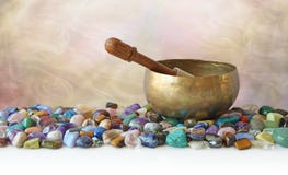 Tibetan Singing Bowl surrounded by tumbled healing stones