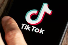 TikTok application icon on Apple iPhone 11 screen close-up.