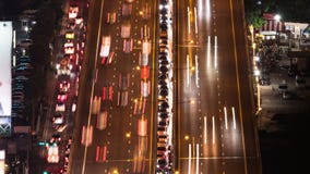 Time-lapse of crowded car traffic transportation on elevated highway or expressway road at night. Urban transport lifestyle