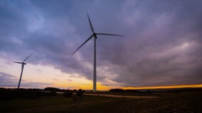 Time lapse motion of Wind Turbine in wind farm on sunset. stock footage Time lapse motion of Wind Turbine in wind farm on sunset. stock footage