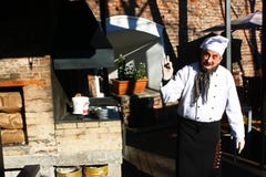 TIMISOARA, ROMANIA- 11.28.2017 A chef with a mustache in front of an oven outside the restaurant makes an ok sign with his fingers royalty free stock images TIMISOARA, ROMANIA- 11.28.2017 A chef with a mustache in front of an oven outside the restaurant makes an ok sign with his fingers royalty free stock images