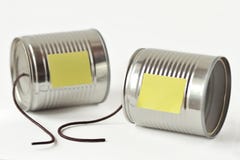 Tin cans phone with broken string and paper note - Communication stock images Tin cans phone with broken string and paper note - Communication stock images
