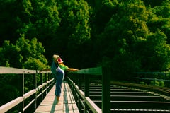 Woman practicing yoga on a rail bridge stock photos Woman practicing yoga on a rail bridge stock photos
