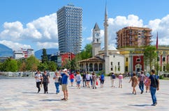 Group of tourists on Skanderbeg square. Efem Bey Mosque, Clock Tower, Plaza Hotel, Tirana, Albania Royalty Free Stock Image Group of tourists on Skanderbeg square. Efem Bey Mosque, Clock Tower, Plaza Hotel, Tirana, Albania Royalty Free Stock Image