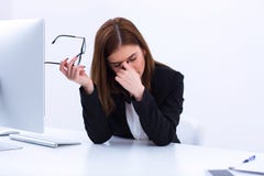 Tired businesswoman rubbing her eyes royalty free stock photo Tired businesswoman rubbing her eyes royalty free stock photo
