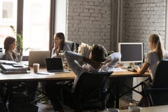 Tired employee relax in chair working in shared office stock image Tired employee relax in chair working in shared office stock image