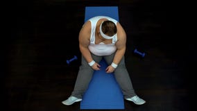 Tired obese male resting after dumbbells exercise, ineffective training program stock photos Tired obese male resting after dumbbells exercise, ineffective training program stock photos