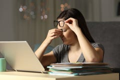 Tired self employed touching eyes working late hours stock image Tired self employed touching eyes working late hours stock image